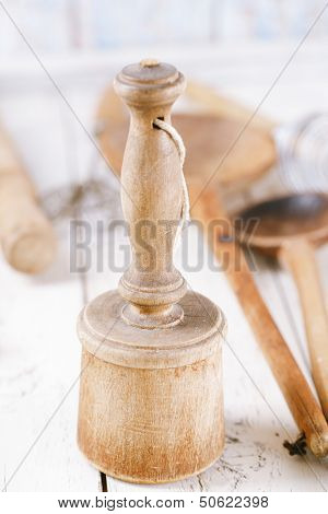 retro kitchen utensils  masher on old wooden table in rustic style