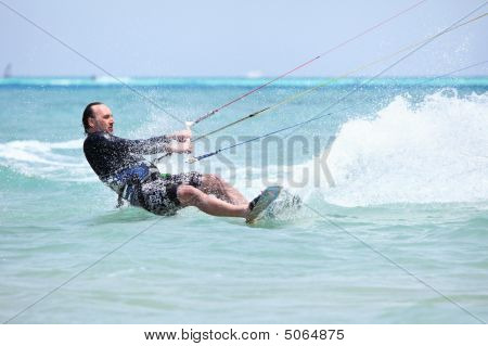 Kiteboarder surf.