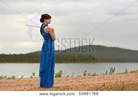 Beautiful Dark Haired Model Strolling Through The Woods.