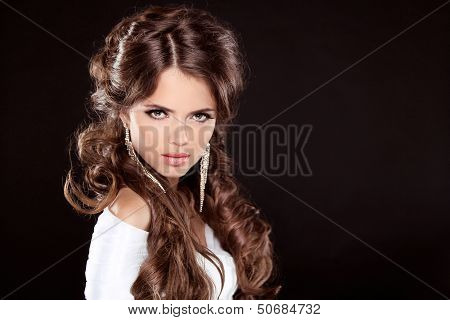 Brunette. Luxury Woman With Long Brown Curly Hair. Fashion Model Portrait Isolated On A Black Backgr