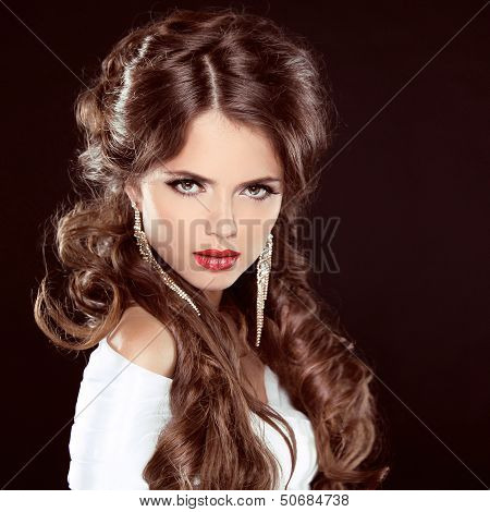 Hairstyle. Beautiful Girl Portrait. Beauty Woman With Brown Curly Long Hair Styling Over Dark. Red L