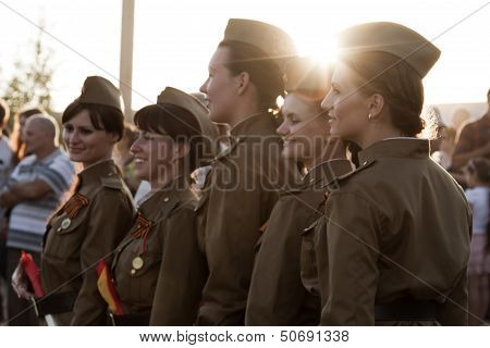 Girls policemen in soldier's uniform of the great Patriotic war in the crowd