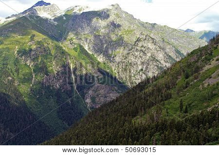 Mountain peaks in Dombai. Summer in cloudy weather