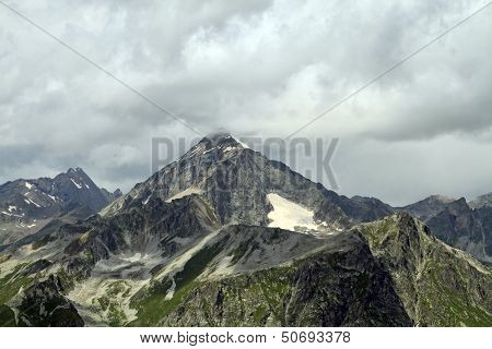 Mountain peaks in Dombai. Summer in cloudy weather