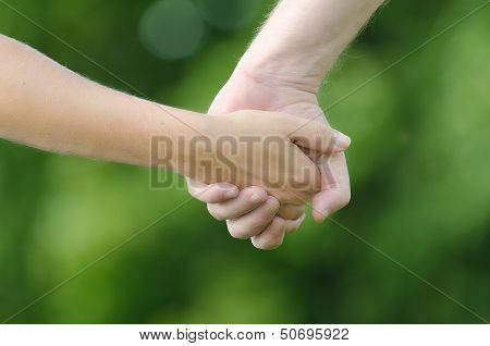 Two people holding hands