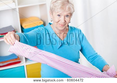 Elderly Woman During Folding Laundry