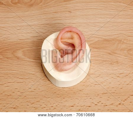 Silicone Human Ear On Wooden Table