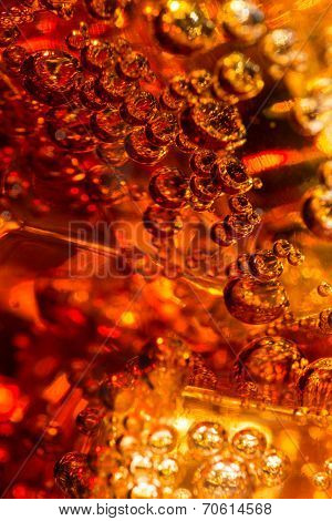 Cola in glass with ice and a bubbles of gas.