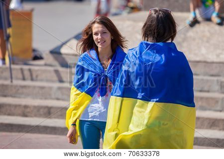 ODESSA, UKRAINE - August 23: Flash mob in city of Odessa on Potemkin Stairs on August 23, 2014, in day of a national flag of Ukraine. Happy participants of summer Flash mob with a flag