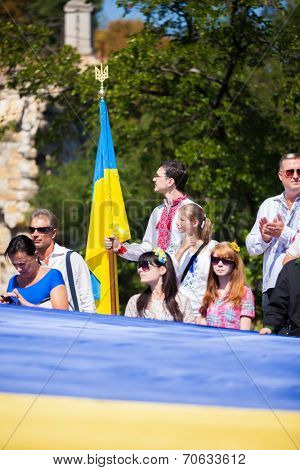 ODESSA, UKRAINE - August 23: Flash mob in city of Odessa on Potemkin Stairs on August 23, 2014, in day of a national flag of Ukraine. Happy participants of summer Flash mob with a flag