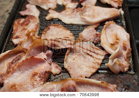 Rashers Of Smoked Bacon On A Griddle