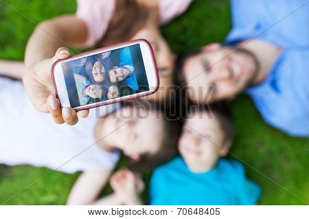 Family taking picture of themselves with smartphone