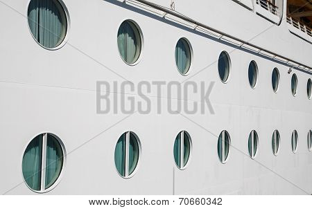 Lines Of Portholes On White Bulkhead
