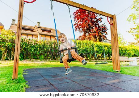 Cute toddler boy having fun outdoors