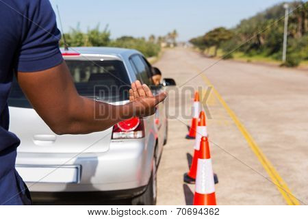 driving instructor teaching young girl to reverse