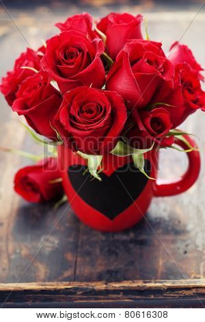 Valentine composition with roses on wooden background