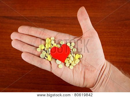 Pills And Heart Shape On The Hand