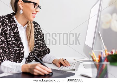 Young creative graphic designer working with computer