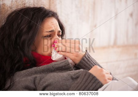 Young sick girl lying in bed