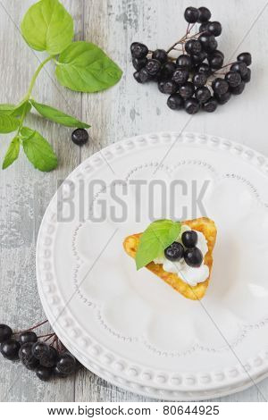 Canape With Cottage Cheese And Black Berries Of Mountain Ash