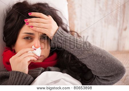 Young sick girl lying in bed