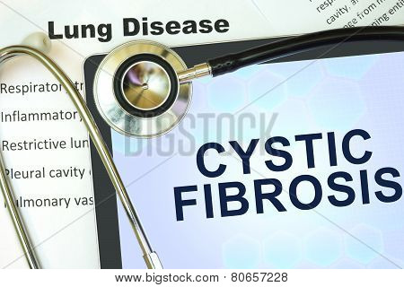 Tablet with word Cystic fibrosis and stethoscope.