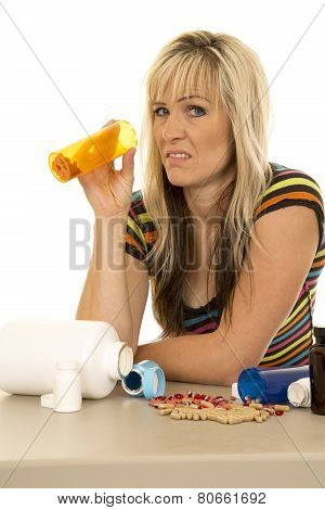 Woman With Pill Bottle And Lots Of Pills Spilled