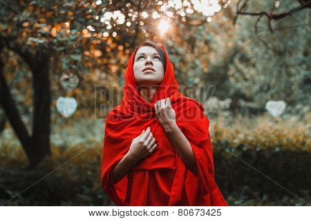Girl In A Red Dress Standing Look Up In The Garden With Hearts