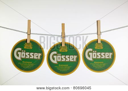 Beermats From Gosser Beer Hanging From A Clothesline.