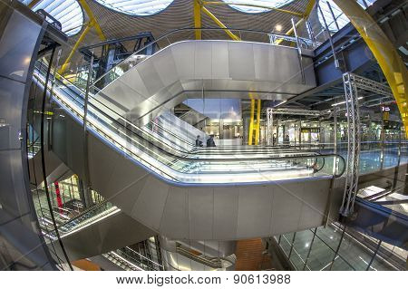 Passengers Walk By At The New Terminal T4 At Barajas Airport On April 1,2012 In Madrid. This Additio