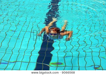 Gli studi di ragazza a swim In una piscina.