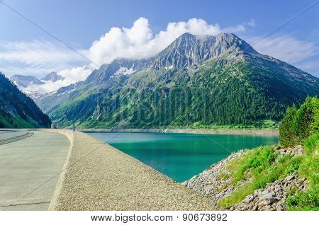 Dam and azure mountain lake in Alps, Austria