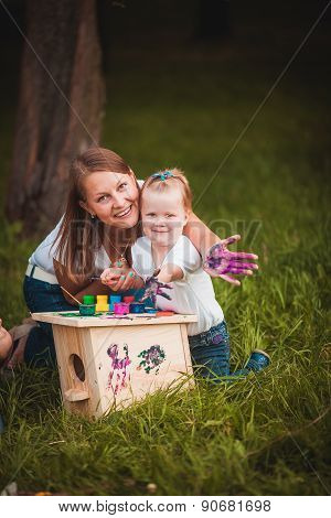 Happy family with nesting box and paints