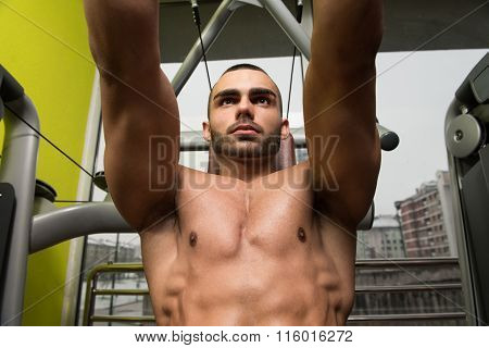 Muscular Male On A Butterfly Machine In Gym
