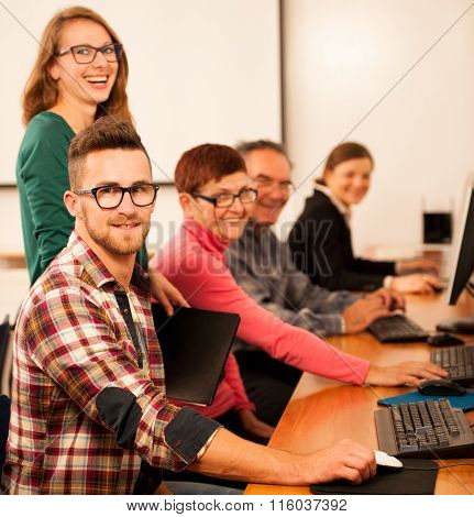 Group Of Adults Learning Computer Skills. Intergenerational Transfer Of Knowledge.