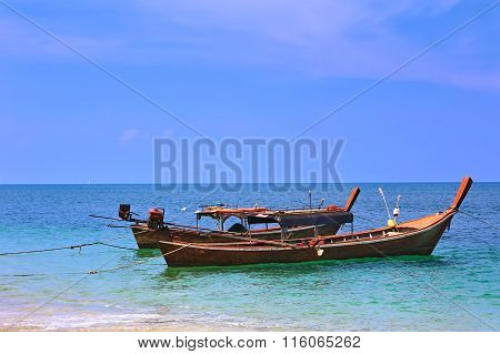Tropical beautiful beach with crystal clear water and boats