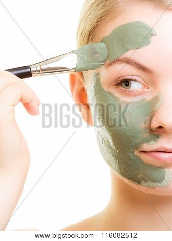 Skin Care. Woman Applying Clay Mud Mask On Face.
