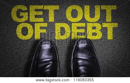 Top View of Business Shoes on the floor with the text: Get Out Of Debt