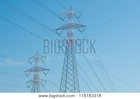 Pylons Of Steel That Are Used To Carry Electrical Current Silhouetted Against The Sky