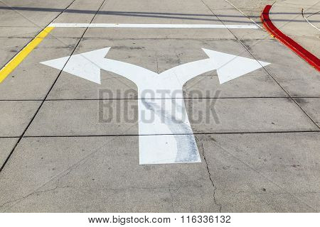 Arrows And Lines On The Asphalt To Indicate The Direction Of Driving