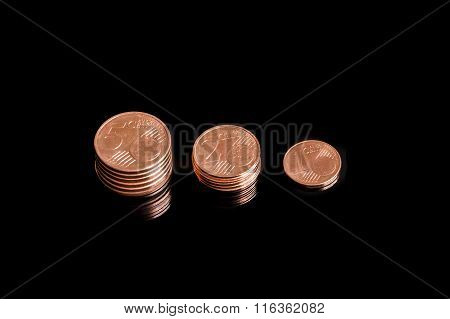 Three shrinking stacks of euro cent coins close-up