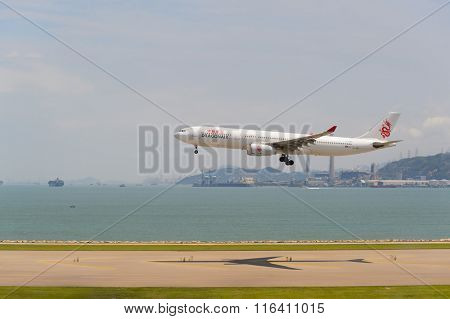 HONG KONG - JUNE 04, 2015: Dragonair aircraft landing at Hong Kong airport. Dragonair is a Hong Kong-based international regional airline