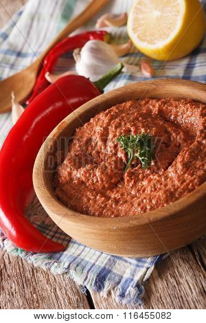 Red Muhammara Snack In Wooden Bowl Closeup. Vertical
