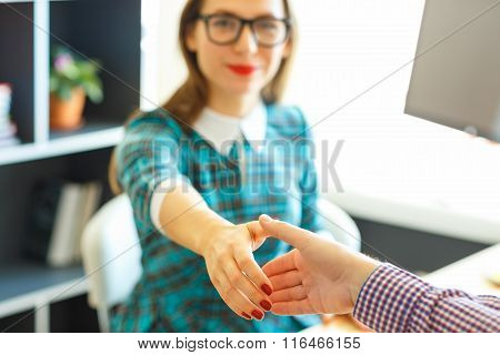 Pretty Young Business Woman With Arm Extended To Handshake