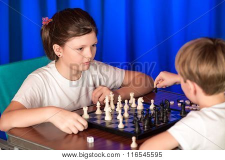 Children Play A Board Game Called Chess.