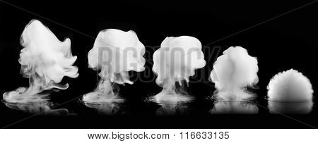 Different white smoke explosions isolated on black background