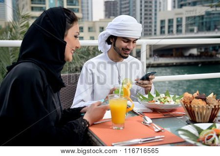 Young Emirati arab couple dining