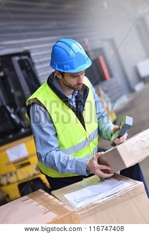 Warehouseman on dock scanning products ready for shipment