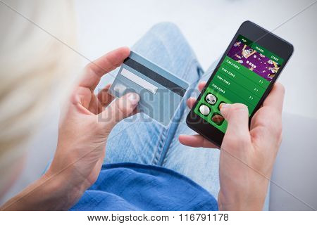 Woman doing online shopping with her mobile phone against gambling app screen