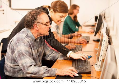 Group Of Adults Learning Computer Skills. Intergenerational Transfer Of Knowledge.